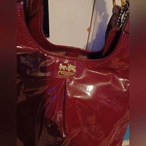 NWOT maroon patent leather Coach bag.